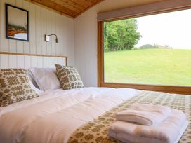 A bedroom with a bed and window view at Defaid Cymreig Oswestry