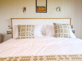 A bedroom with a bed and pillows at Defaid Cymreig in Oswestry