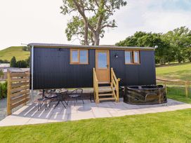 A tiny house with steps and a hot tub at Defaid Cymreig Oswestry