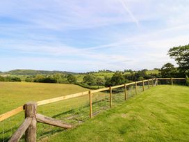 A view of hills and a fence in a grassy area at Defaid Cymreig in Oswestry