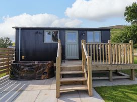 A cabin with a hot tub and stairs at Cheviot in Oswestry