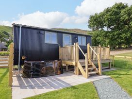 An outdoor area with a hot tub and decking at Cheviot in Oswestry