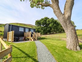 A house with a deck and a tree in the garden at Cheviot in Oswestry
