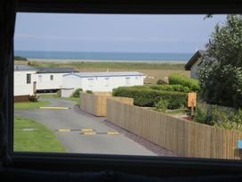 A view of caravans and sea from a property at Puffin Way Holiday Caravan