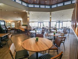 An indoor dining area with tables and chairs at Puffin Way Holiday Caravan