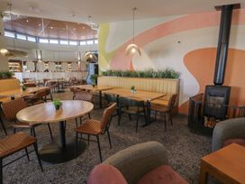 A dining room with tables and chairs at Puffin Way Holiday Caravan 