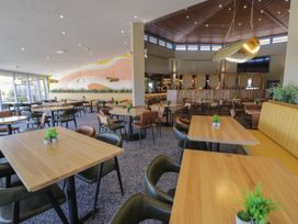 A dining room with tables and chairs at Puffin Way Holiday Caravan