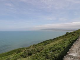 A coastal view overlooking the ocean and hills at Puffin Way Holiday Caravan