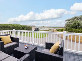 An outdoor area with seating and a view at 8 Puffin Way in Llwyngwril