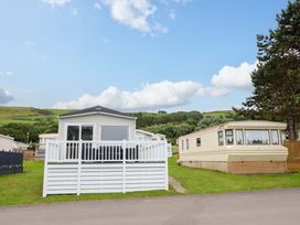 Two caravans with a lawn and hills at 8 Puffin Way Llwyngwril