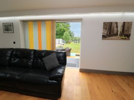 A living room with a sofa and curtains at Silver Copse in Frilford Heath Near Abingdon