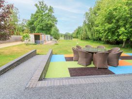 A garden with a dining table and chairs at Silver Copse Frilford Heath Near Abingdon