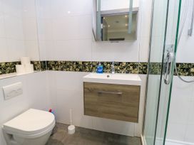 A bathroom with a sink, toilet, and shower at Silver Copse in Frilford Heath Near Abingdon