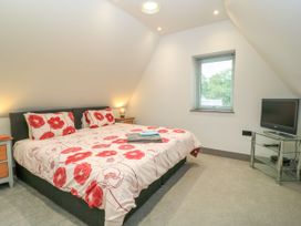 A bedroom with a bed and television at Silver Copse Frilford Heath Near Abingdon
