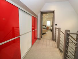 A hallway with a sliding wardrobe and door at Silver Copse Frilford Heath Near Abingdon
