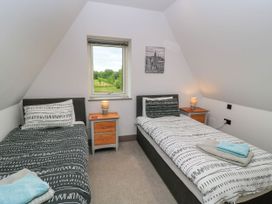 A bedroom with two beds and a window at Silver Copse Frilford Heath Near Abingdon