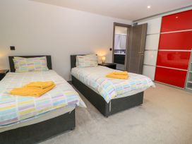 A bedroom with two beds and a wardrobe at Silver Copse Frilford Heath Near Abingdon