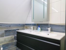 A bathroom with a double sink and mirror at Silver Copse Frilford Heath Near Abingdon