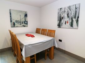 A dining room with a table and chairs at Silver Copse in Frilford Heath Near Abingdon
