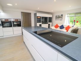 A kitchen with oven, cooking hob and sofa at Silver Copse Frilford Heath Near Abingdon