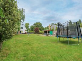 A garden with a trampoline and a shed at Silver Copse Frilford Heath Near Abingdon