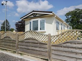 A house with a fence and trees at Cherry Tree in Kidlington