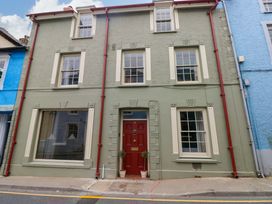 A building facade with a front door and windows at 18 Main Street