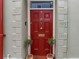 An entryway with a red door number 18 at 18 Main Street
