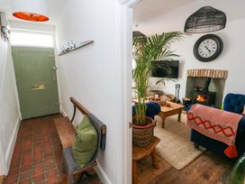 A hallway with a front door and coat hooks at 18 Main Street 