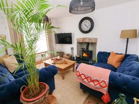 A living room with a fireplace and sofas at 18 Main Street