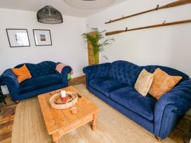 A living room with sofas and a wooden table at 18 Main Street