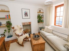 A living room with a couch and a rocking chair at 18 Main Street