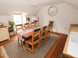 A dining room with a table and chairs at 18 Main Street