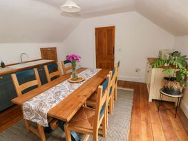 A dining room with a table and chairs at 18 Main Street