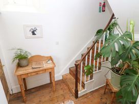 A hallway with stairs and a table at 18 Main Street