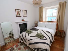 A bedroom with a bed and a mirror at 18 Main Street