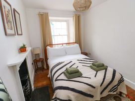 A bedroom with a bed and a lamp at 18 Main Street