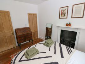 A bedroom with a bed and chest of drawers at 18 Main Street