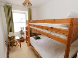 A bedroom with a bunk bed and a side table at 18 Main Street