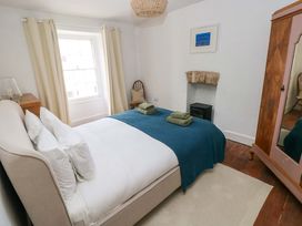 A bedroom with a bed and window at 18 Main Street