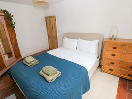 A bedroom with a bed and dresser at 18 Main Street