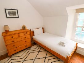A bedroom with a single bed and a dresser at 18 Main Street