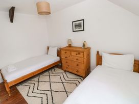 A bedroom with two beds and a dresser at 18 Main Street