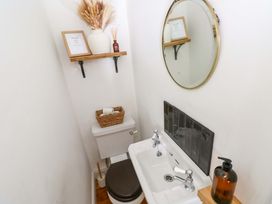 A small bathroom with a sink and toilet at 18 Main Street