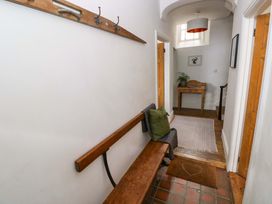 A hallway with a bench and coat hooks at 18 Main Street