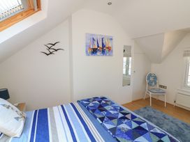 A bedroom with a bed and a chair at The Hideaway