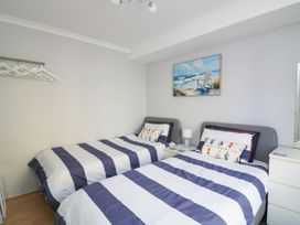 A bedroom with two beds and a painting at The Hideaway