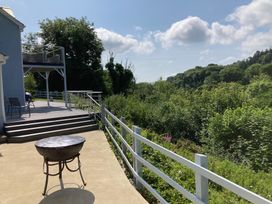 An outdoor area with a deck and seating at 1 Bryn Beudy in Narberth