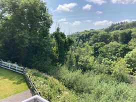 A landscape view with trees and grass at 1 Bryn Beudy in Narberth