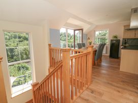 A staircase leading to a kitchen area at 1 Bryn Beudy in Stepaside